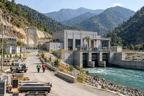 AI-generated illustrative hydropower site with a service route. Not a customer installation.